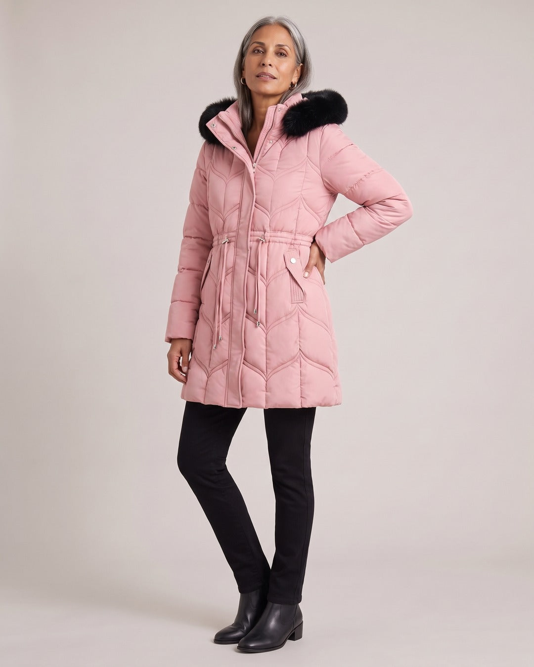 Long Puffer Coat with Faux-Fur Hood worn by a model, Pink