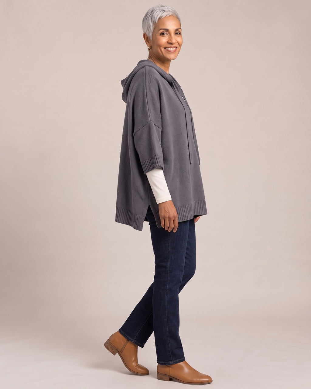 Oversized Knit Poncho Hoodie worn by a model, side view