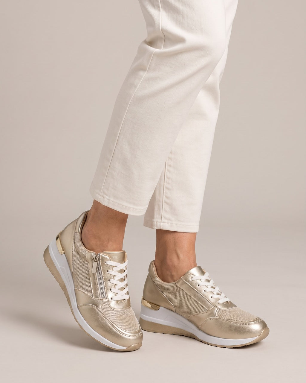 Metallic Side-Zip Wedge Trainer in Gold, worn